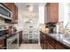 Open-concept kitchen with dark countertops and view into the dining area and staircase at 14145 N 92Nd St # 2077, Scottsdale, AZ 85260