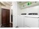 Clean laundry room with white washer, dryer, and ample cabinet storage at 14145 N 92Nd St # 2077, Scottsdale, AZ 85260