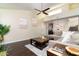 Comfortable living room with dark wood floors, neutral walls, and view into dining area at 14145 N 92Nd St # 2077, Scottsdale, AZ 85260