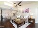 Open-concept living room with dark wood floors, staircase, and view into dining area at 14145 N 92Nd St # 2077, Scottsdale, AZ 85260