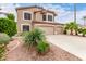 Landscaped front yard with mature shrubbery leads to this lovely two-story home with a three-car garage at 1567 S Western Skies Dr, Gilbert, AZ 85296