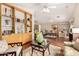 Expansive living area featuring warm hardwood floors, a ceiling fan, and custom built-in shelving at 1567 S Western Skies Dr, Gilbert, AZ 85296