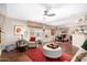 Open-concept living room with hardwood floors, comfortable seating, and a dining area with natural light at 1567 S Western Skies Dr, Gilbert, AZ 85296
