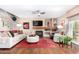 Cozy living room featuring a fireplace, hardwood floors, and comfortable seating with plenty of natural light at 1567 S Western Skies Dr, Gilbert, AZ 85296