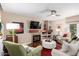 Comfortable living room features a cozy fireplace, neutral tones, and a ceiling fan for added comfort at 1567 S Western Skies Dr, Gilbert, AZ 85296