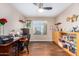Well-lit home office with built-in shelves, a spacious desk, and a large window at 1567 S Western Skies Dr, Gilbert, AZ 85296