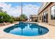 Inviting pool area with a spa, patio seating, and serene landscaping, ideal for relaxation at 1567 S Western Skies Dr, Gilbert, AZ 85296