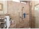 Tiled shower with stone flooring, built-in seat, and updated fixtures at 1567 S Western Skies Dr, Gilbert, AZ 85296