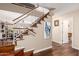 Elegant staircase with wood steps, white railings and lovely wood floors in a bright interior at 1567 S Western Skies Dr, Gilbert, AZ 85296