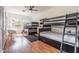 Spacious bedroom features two sets of bunkbeds, offering ample sleeping space in a bright and airy setting at 16446 N 59Th St, Scottsdale, AZ 85254