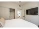 Bright bedroom features a closet, a wall mounted TV and a comfortable bed with stylish, modern decor at 16446 N 59Th St, Scottsdale, AZ 85254