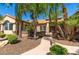 Exterior elevation of a house with mature palm trees in the front yard at 16446 N 59Th St, Scottsdale, AZ 85254