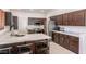 Modern kitchen with stainless steel appliances, dark wood cabinets, and light countertops at 16446 N 59Th St, Scottsdale, AZ 85254