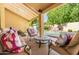 Inviting outdoor patio featuring comfortable seating overlooking a pristine swimming pool and lush landscaping at 16446 N 59Th St, Scottsdale, AZ 85254