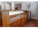 Indoor wet bar with sink, mini-refrigerator, and wooden cabinetry at 16446 N 59Th St, Scottsdale, AZ 85254