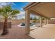An inviting backyard featuring a pool, patio area, and lush palm tree, perfect for outdoor enjoyment at 19008 N Lousandra Dr, Maricopa, AZ 85138