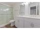 Bathroom featuring double sinks, a glass-enclosed shower, and modern fixtures, combining style and functionality at 19008 N Lousandra Dr, Maricopa, AZ 85138