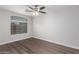 Comfortable bedroom features stylish flooring and a large window for natural light at 19008 N Lousandra Dr, Maricopa, AZ 85138
