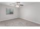 A bedroom featuring a ceiling fan, window, and plush carpet, offering a peaceful atmosphere at 19008 N Lousandra Dr, Maricopa, AZ 85138