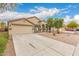 Inviting single-story home with a spacious driveway and xeriscaped front yard at 19008 N Lousandra Dr, Maricopa, AZ 85138