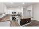 Kitchen features white cabinets, stainless steel appliances, granite countertops, and a large island at 19008 N Lousandra Dr, Maricopa, AZ 85138