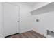 Laundry room features tile flooring, a storage shelf, and convenient access to an exterior door at 19008 N Lousandra Dr, Maricopa, AZ 85138