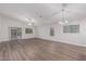 Bright living room features vaulted ceilings, modern lighting, and sliding glass doors to backyard at 19008 N Lousandra Dr, Maricopa, AZ 85138
