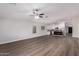 Spacious living area opens to a modern kitchen with stainless steel appliances and granite countertops at 19008 N Lousandra Dr, Maricopa, AZ 85138
