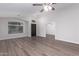 Open-concept living room features new flooring and a welcoming front entry at 19008 N Lousandra Dr, Maricopa, AZ 85138