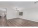 Bright living room showcasing modern flooring, a ceiling fan and lots of natural light at 19008 N Lousandra Dr, Maricopa, AZ 85138