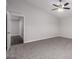 Another shot of the spacious main bedroom with plush carpet, ceiling fan, and a doorway to a walk-in closet at 19008 N Lousandra Dr, Maricopa, AZ 85138