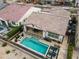 An aerial view of a backyard with a pool, fire pit and patio with dining area at 20528 W Coolidge St, Buckeye, AZ 85396