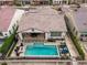 An aerial view of a backyard with a pool, fire pit and patio with dining area at 20528 W Coolidge St, Buckeye, AZ 85396