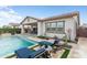 Beautiful backyard with a pool, outdoor kitchen, covered patio, and desert views, perfect for entertaining at 20528 W Coolidge St, Buckeye, AZ 85396
