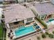 An aerial view of a backyard with a pool, fire pit and patio with dining area at 20528 W Coolidge St, Buckeye, AZ 85396