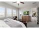 Bright bedroom with many windows features a wooden dresser with a TV at 20528 W Coolidge St, Buckeye, AZ 85396