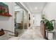 Bright entryway with tile flooring, console table, and access to an outdoor courtyard through sliding glass doors at 20528 W Coolidge St, Buckeye, AZ 85396