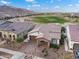 Aerial view of home with desert landscaping with golf course in back and tile roof at 20528 W Coolidge St, Buckeye, AZ 85396
