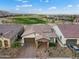 Aerial view of home with desert landscaping, with golf course in back and tile roof at 20528 W Coolidge St, Buckeye, AZ 85396