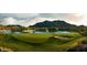Scenic view of the lush green golf course with lake and mountain backdrop at 20528 W Coolidge St, Buckeye, AZ 85396