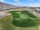 Aerial view of a green golf course nestled in a residential community and mountain background at 20528 W Coolidge St, Buckeye, AZ 85396