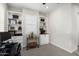 Bright home office featuring custom built-ins, neutral paint and carpet, and a window with shutters for privacy at 20528 W Coolidge St, Buckeye, AZ 85396