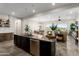 Open kitchen island with granite countertops, stainless steel appliances, and ample storage overlooks the living and dining areas at 20528 W Coolidge St, Buckeye, AZ 85396
