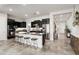 Modern kitchen with a granite island, black cabinetry, and stainless steel appliances at 20528 W Coolidge St, Buckeye, AZ 85396