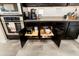 Kitchen showcasing modern appliances, dark cabinetry, granite countertops, and convenient pull-out shelves at 20528 W Coolidge St, Buckeye, AZ 85396