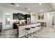 Modern kitchen with a granite island, black cabinetry, and stainless steel appliances at 20528 W Coolidge St, Buckeye, AZ 85396