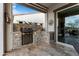Outdoor kitchen with stone accents, built-in grill, and countertop space for seamless entertaining and dining at 20528 W Coolidge St, Buckeye, AZ 85396