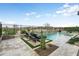 Inviting backyard pool with lounge chairs, desert plants, and a view of the desert landscape at 20528 W Coolidge St, Buckeye, AZ 85396