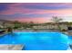Stunning pool with water feature at sunset, and golf course views at 20528 W Coolidge St, Buckeye, AZ 85396
