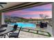 Outdoor pool and patio area at dusk, with lounge chairs and mountain views at 20528 W Coolidge St, Buckeye, AZ 85396